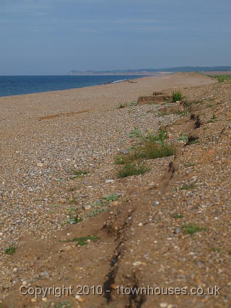 E3113429.JPG - The craggy ridge at the back of the beach is disappearing each year