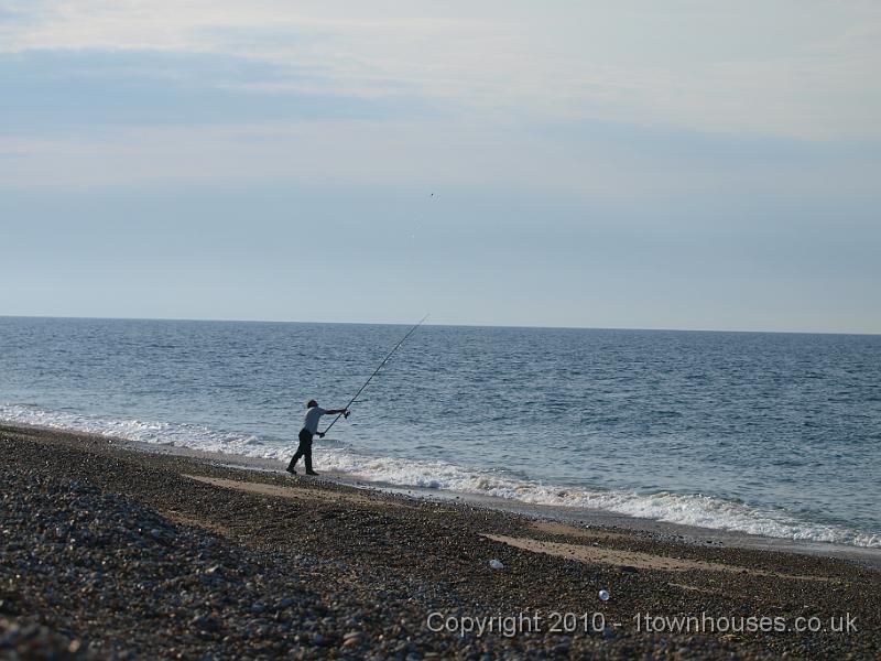 E3113478.JPG - More angling - if they try hard they can foul gear on the vera from the shore...